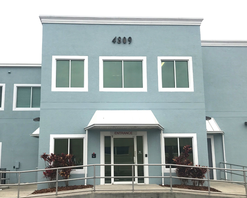 The Defy Medical Tampa clinic, a blue two-story building.