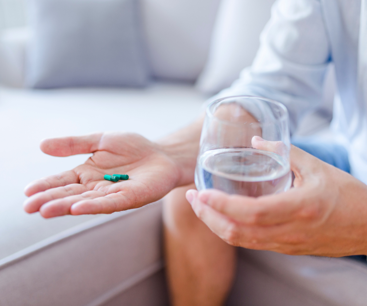 A man holds prescription pills he received through Defy Medical Primary Care.