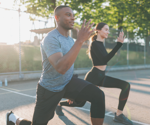 Healthy man and woman exercising outdoors