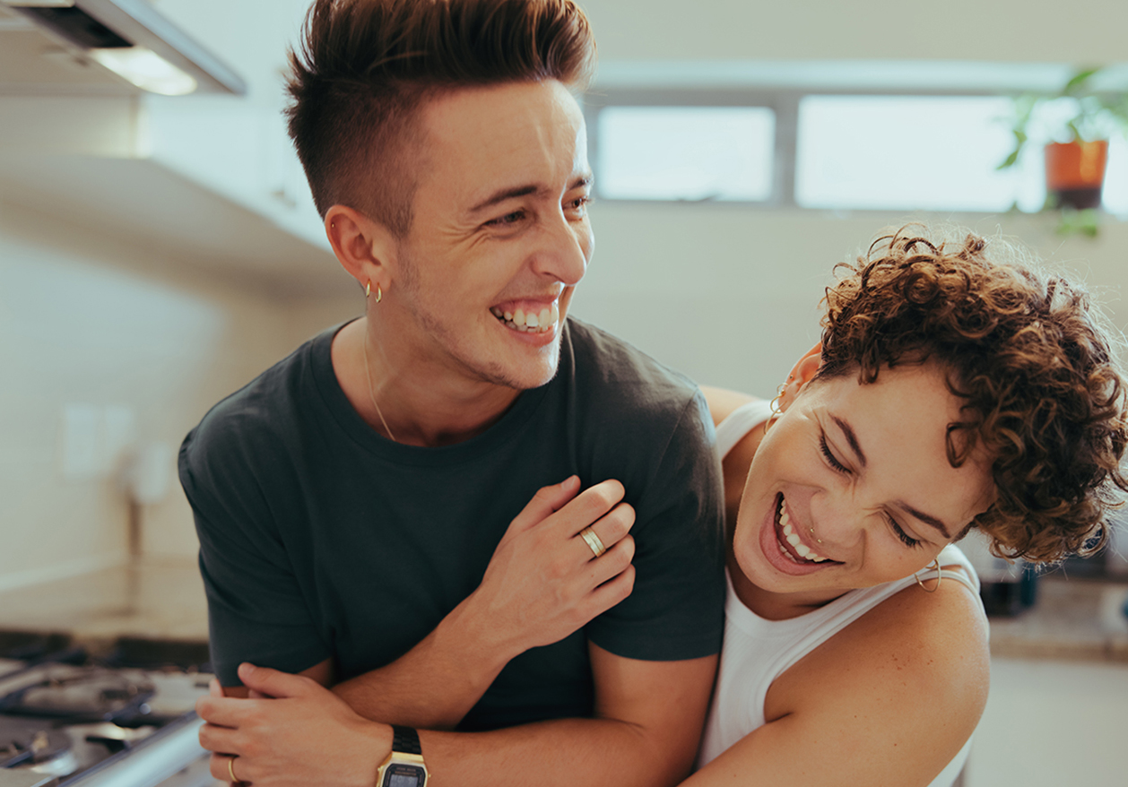 Couple hugging and smiling.