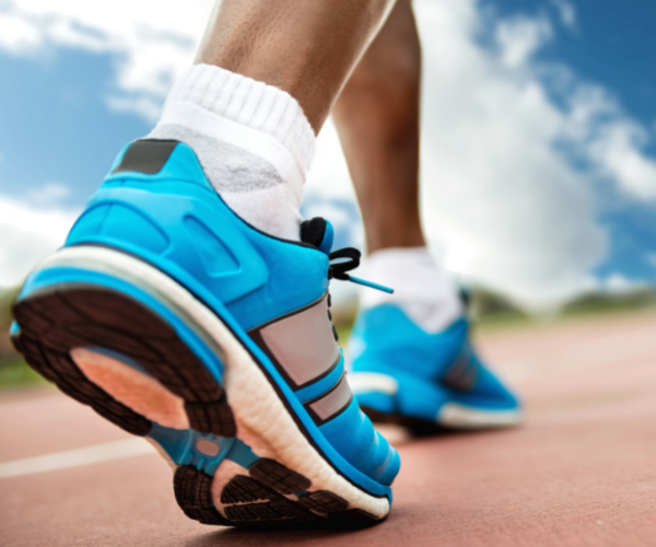 Closeup of running shoes on a track.