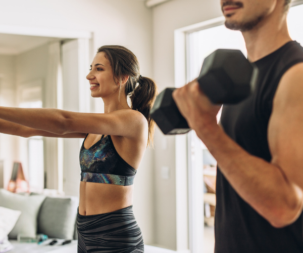 Man and woman lifting weights