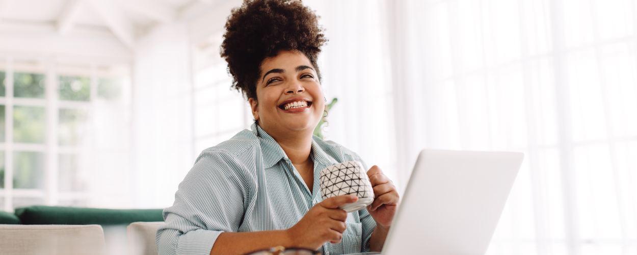 A plus sized women smiles as she signs up for semaglutide for weight loss with defy medical online.