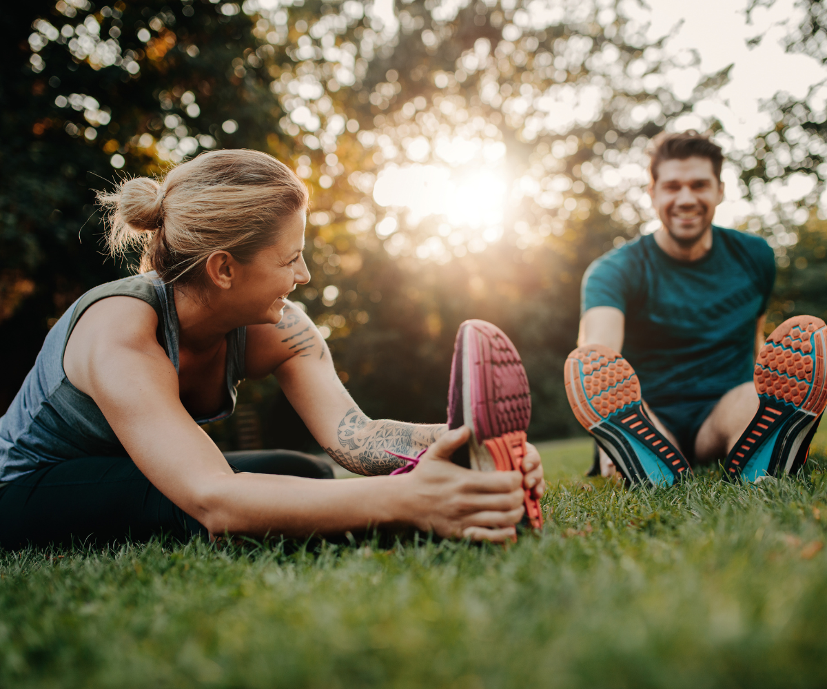 A man and a woman stretch before running as they discuss semaglutide versus liraglutide for weight loss.