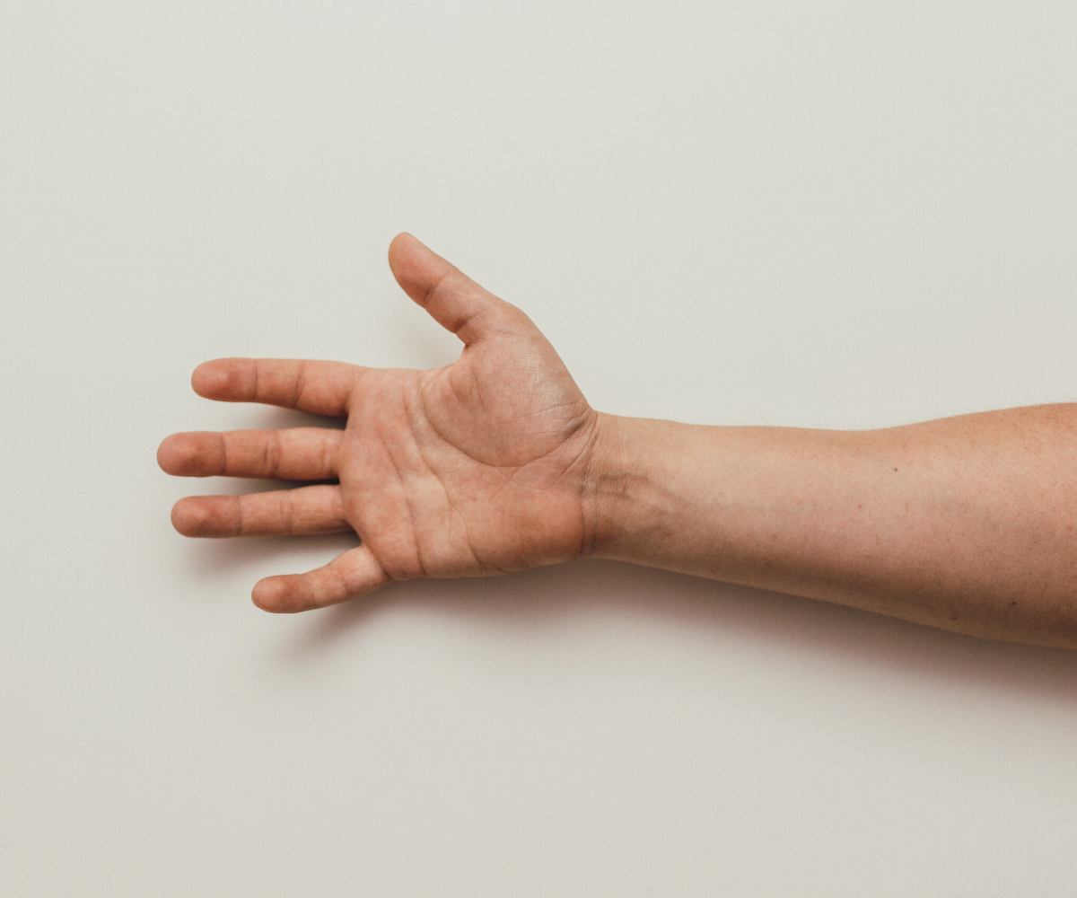 A man stretches out his hand to try the testosterone finger length test.
