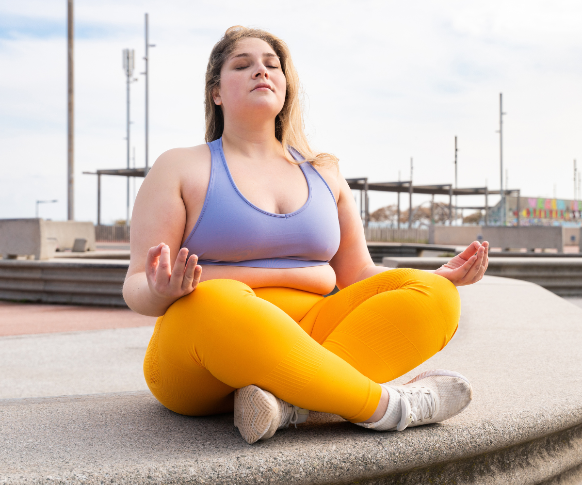 A plus sized woman practices yoga as part of her active lifestyle alongside tirzepatide for weight loss.